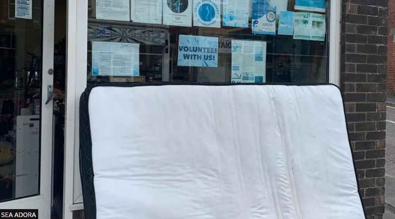 Sea Adora Image of fly tipped mattress outside charity shop